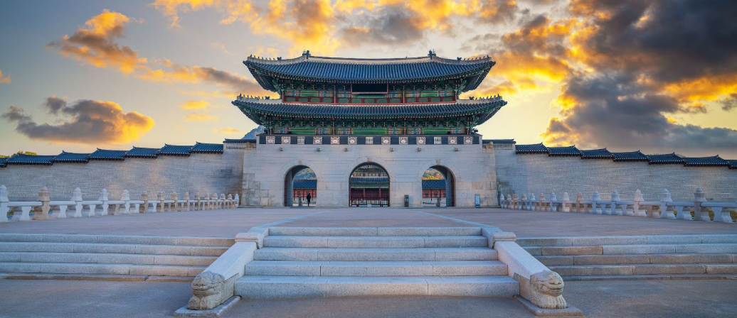 Traditional Korean building with a sunset sky